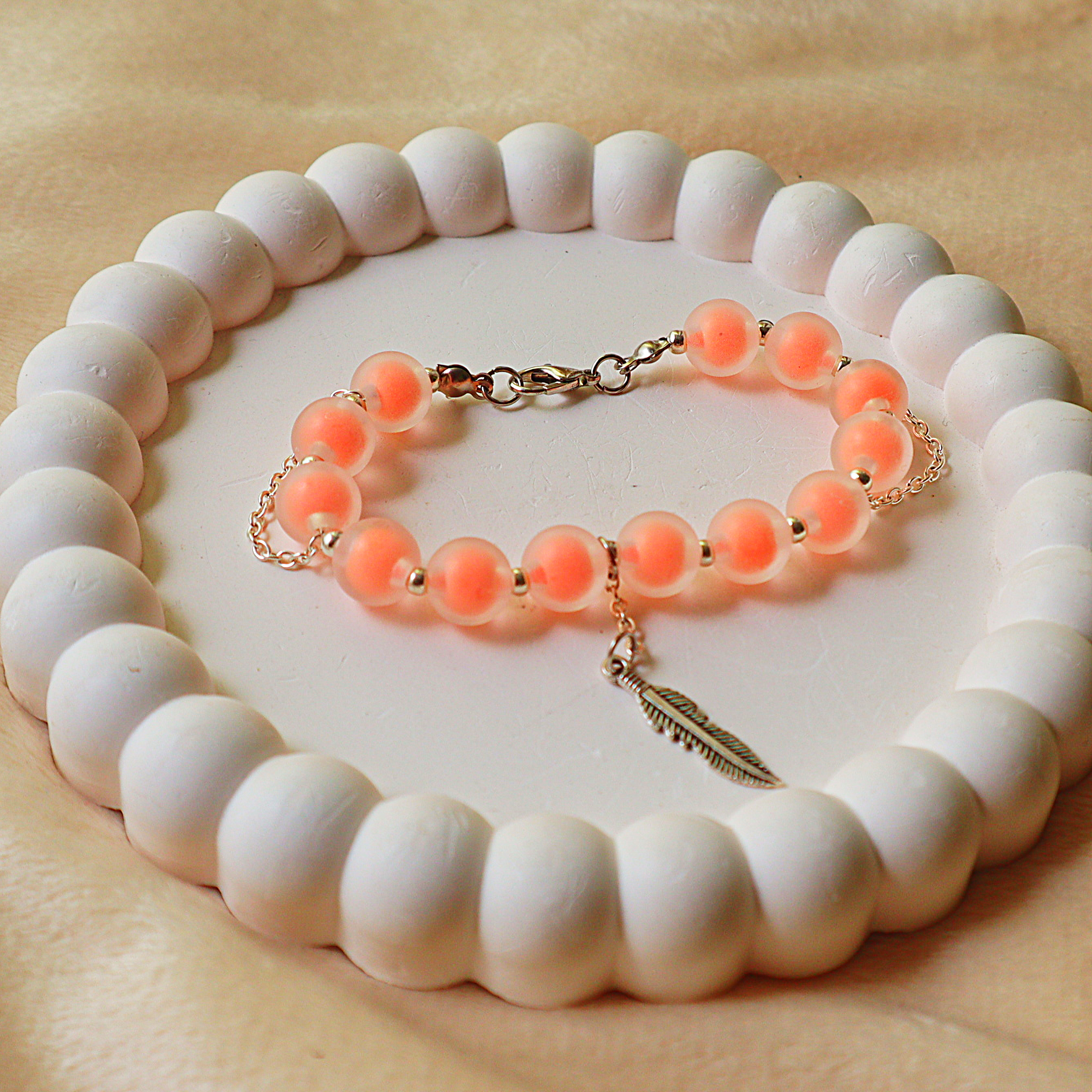 Frosted Peach Beaded Charm Bracelet – Warm Coral Glass Beads with Silver Feather Charm