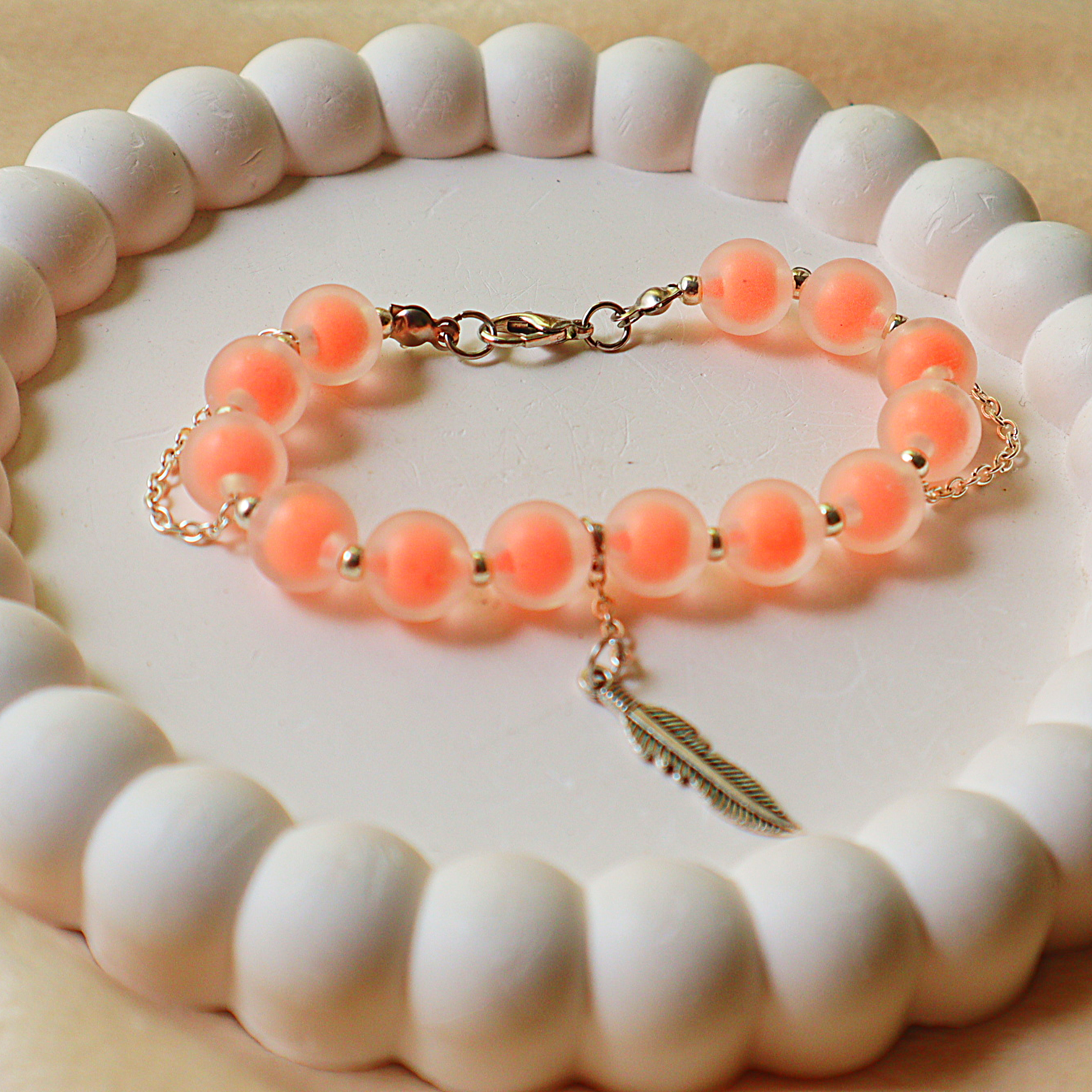 Frosted Peach Beaded Charm Bracelet – Warm Coral Glass Beads with Silver Feather Charm