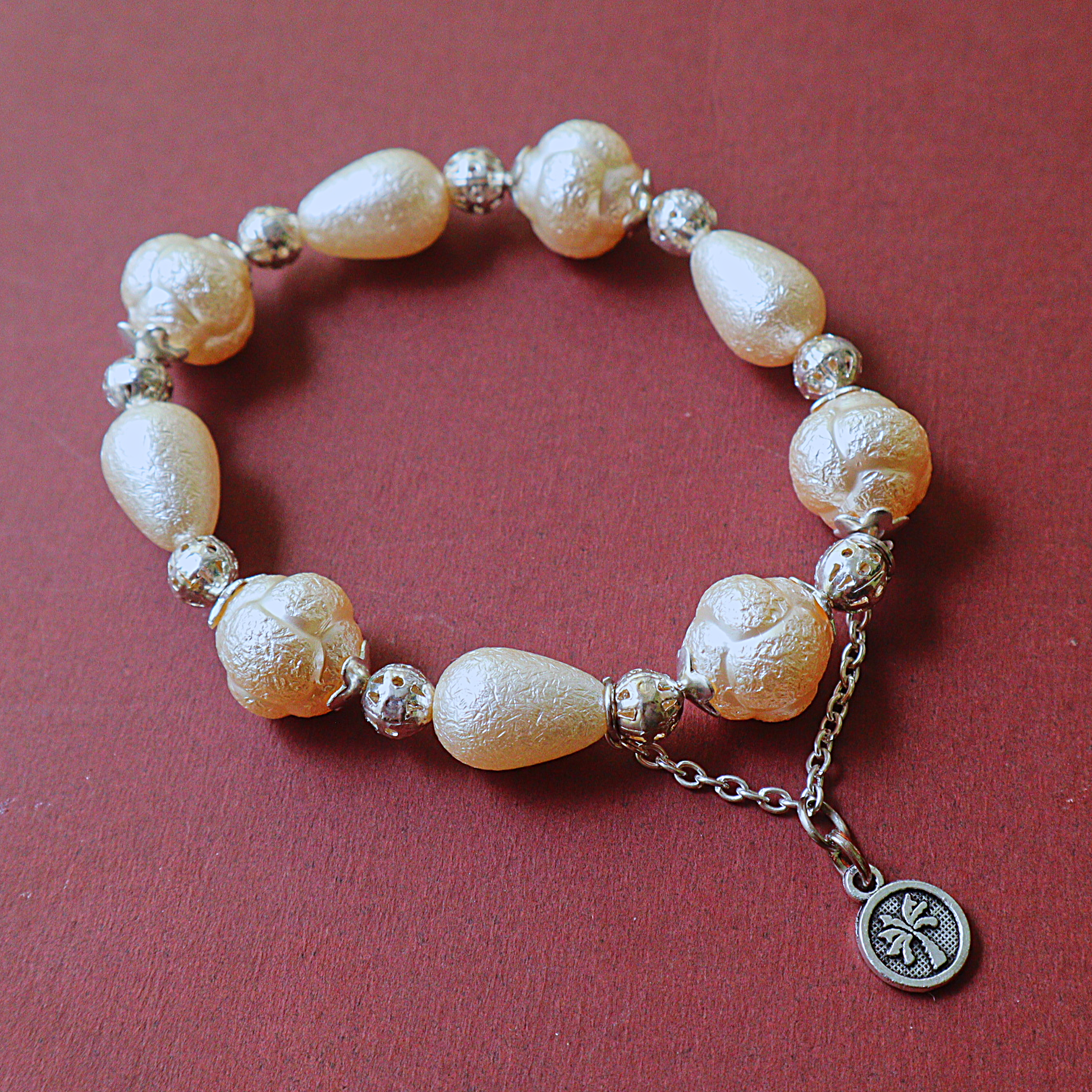 Ivory Textured Pearl Bead Bracelet with Silver Filigree Spacers & Palm Coin Charm