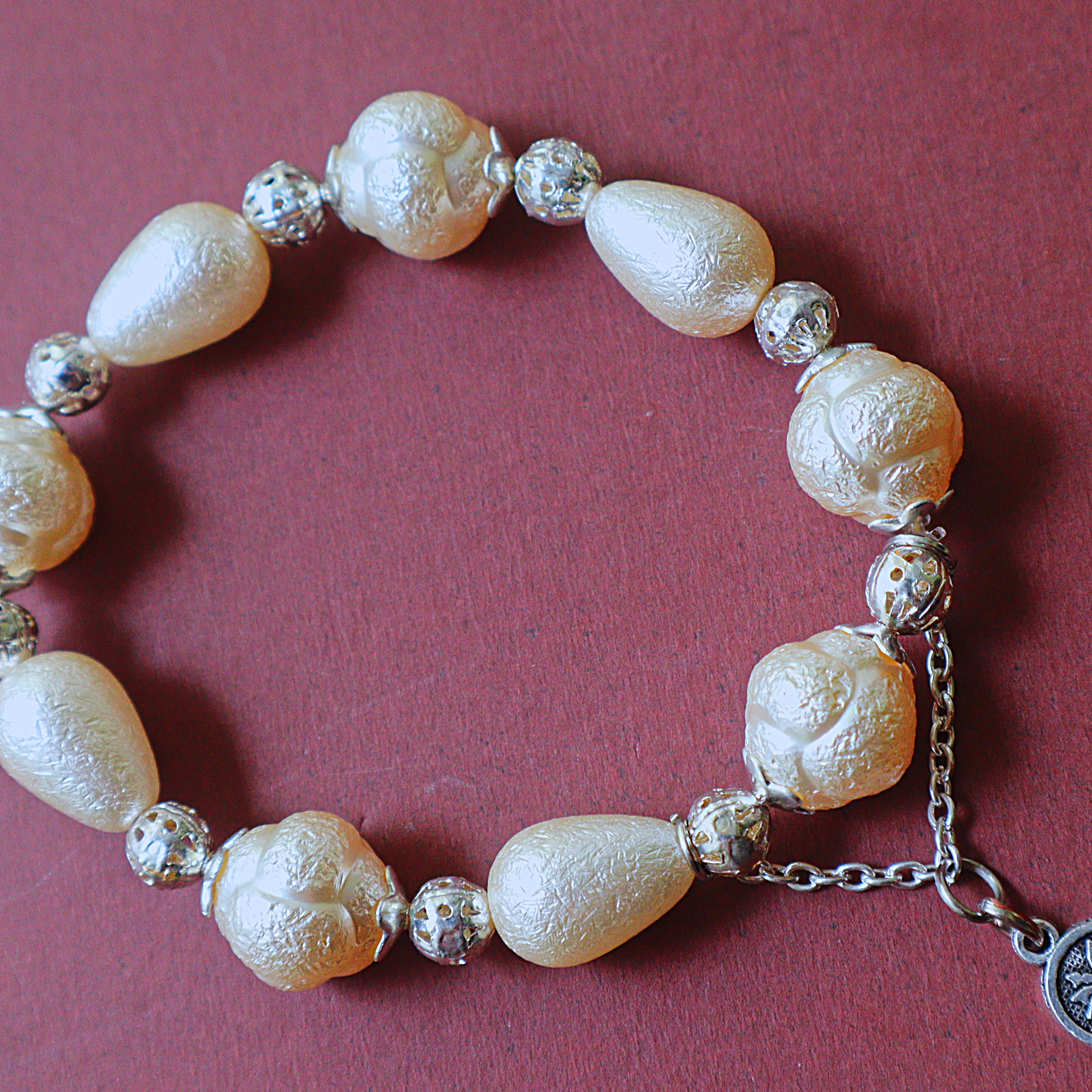 Ivory Textured Pearl Bead Bracelet with Silver Filigree Spacers & Palm Coin Charm