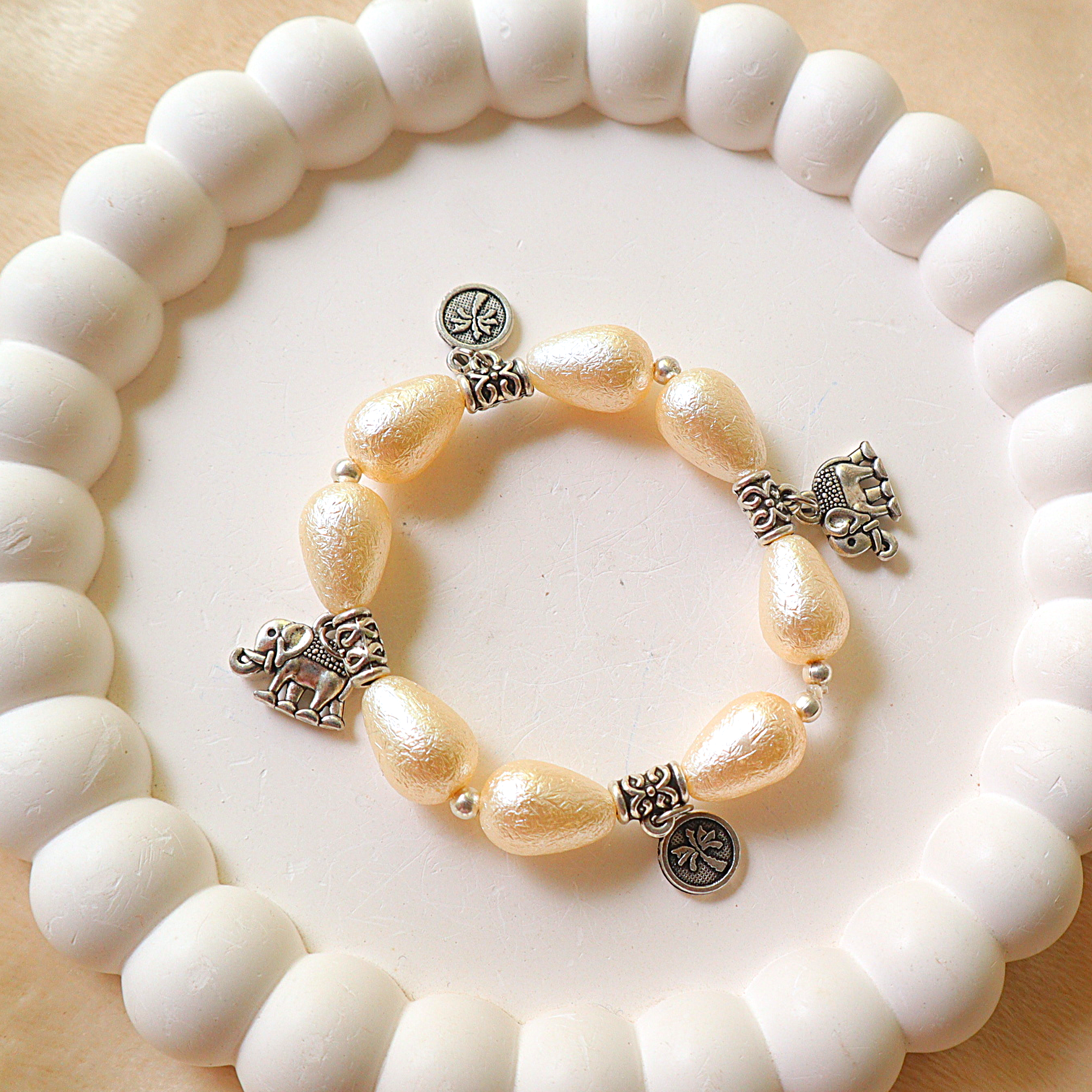 Ivory Pearlescent Drop Bead Bracelet with Silver Elephant & Palm Tree Charms