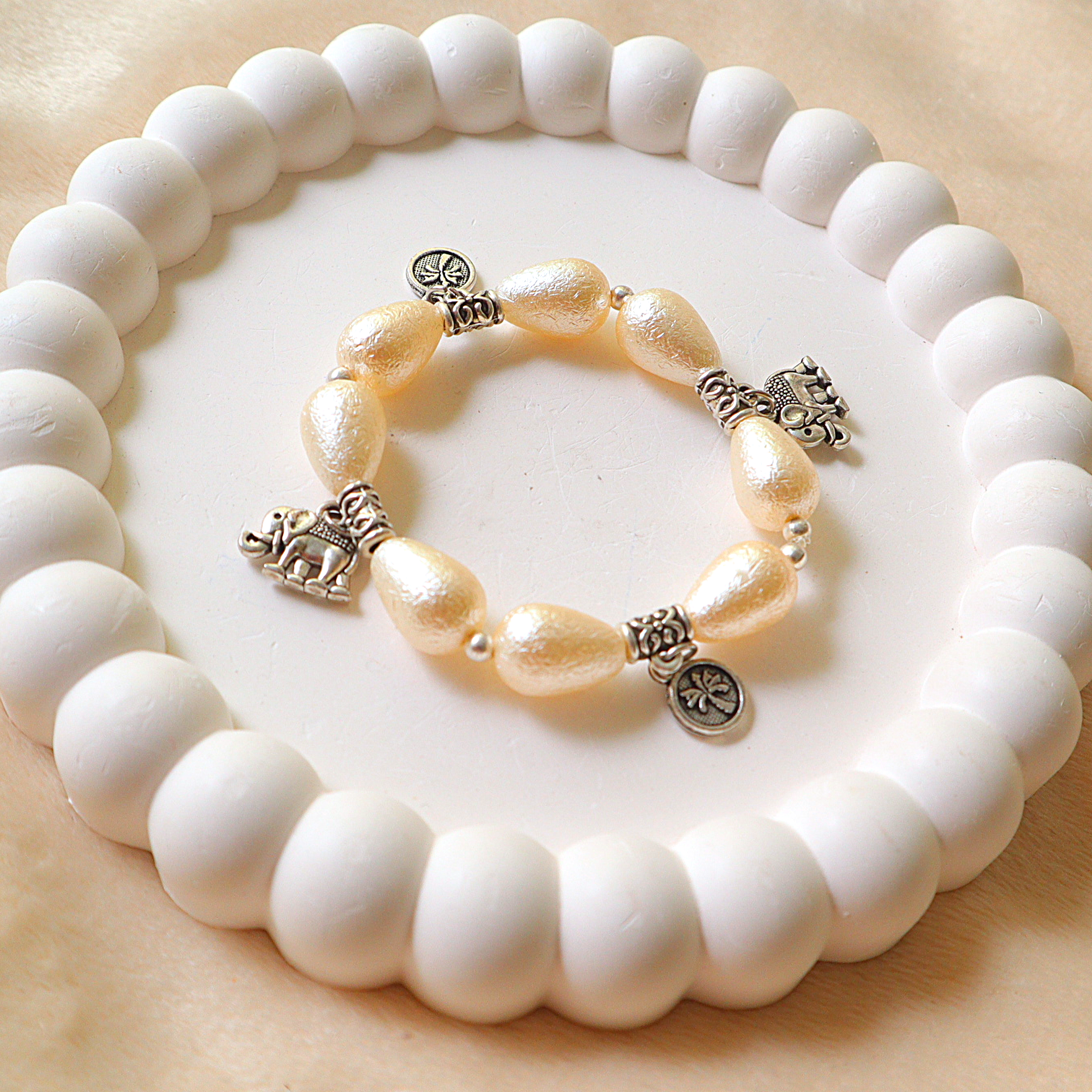 Ivory Pearlescent Drop Bead Bracelet with Silver Elephant & Palm Tree Charms