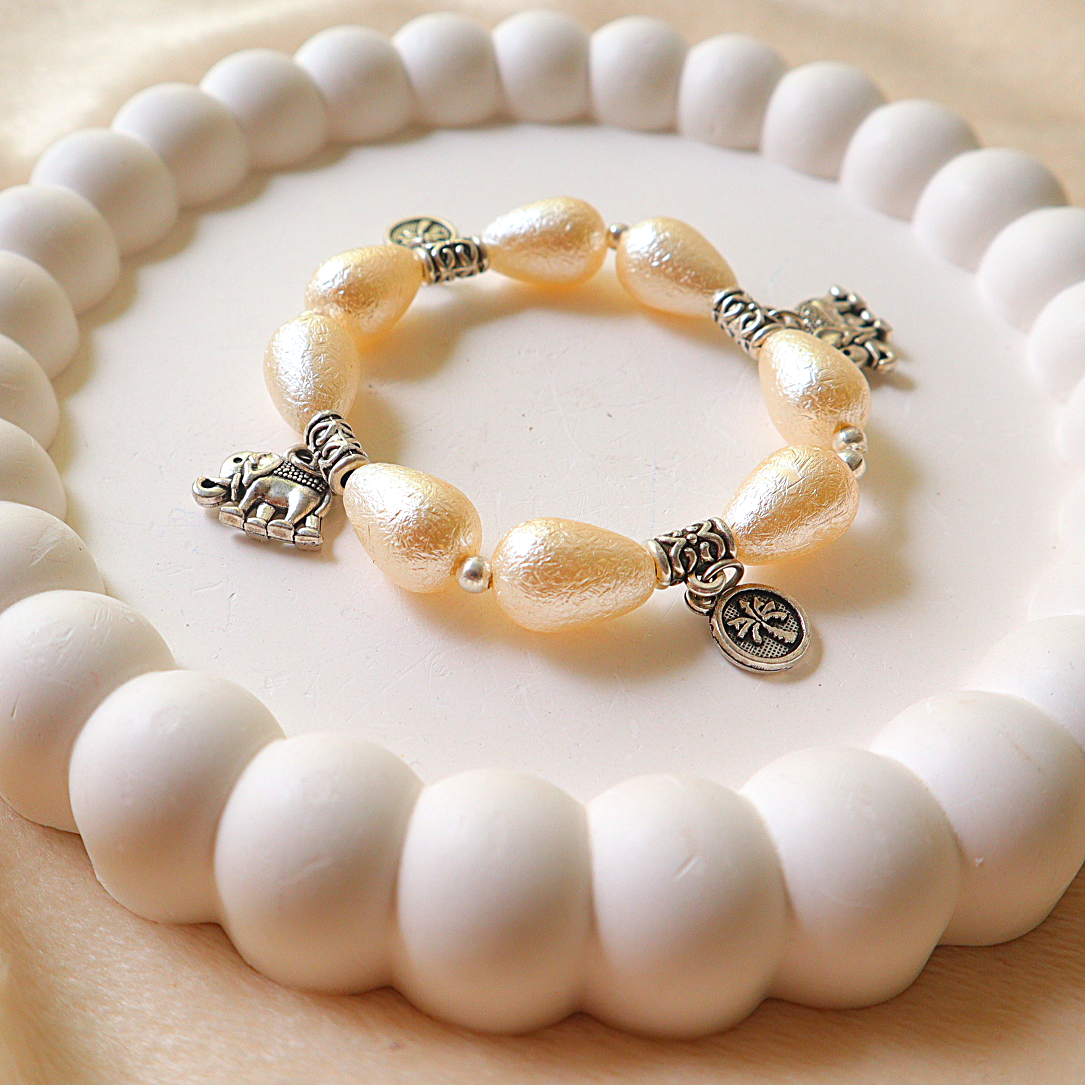 Ivory Pearlescent Drop Bead Bracelet with Silver Elephant & Palm Tree Charms
